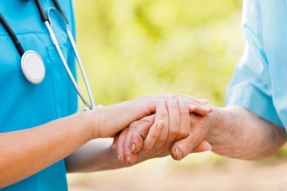 Nurse holding patients hand 