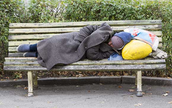 Man sleeping rough on a bench