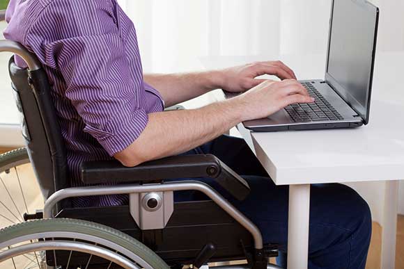 Wheelchair user on laptop