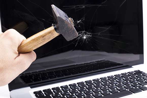 Hammer smashing a computer screen