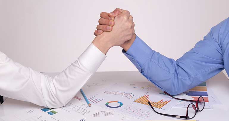 Business people arm wrestling