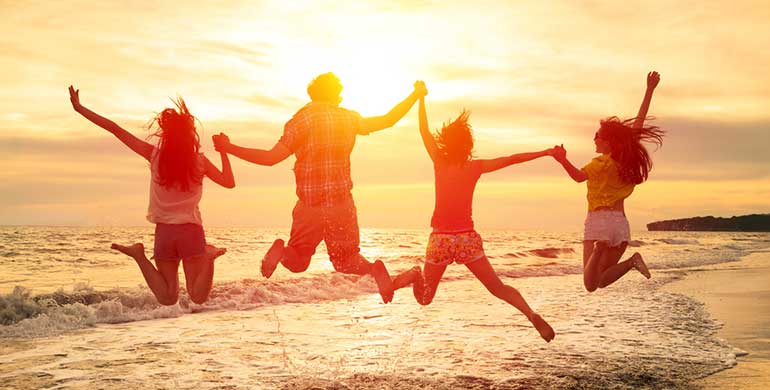 Young people jumping on beach