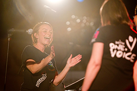 Woman singing in With One Voice choir