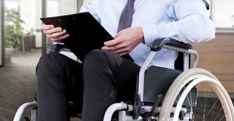 Man in wheelchair with clipboard