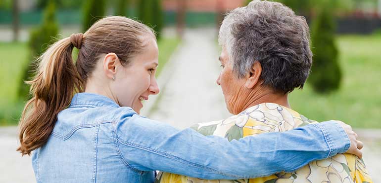 Young unpaid carer with elderly lady