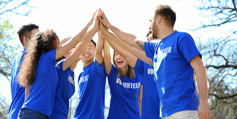 Happy Volunteers with hands in the air