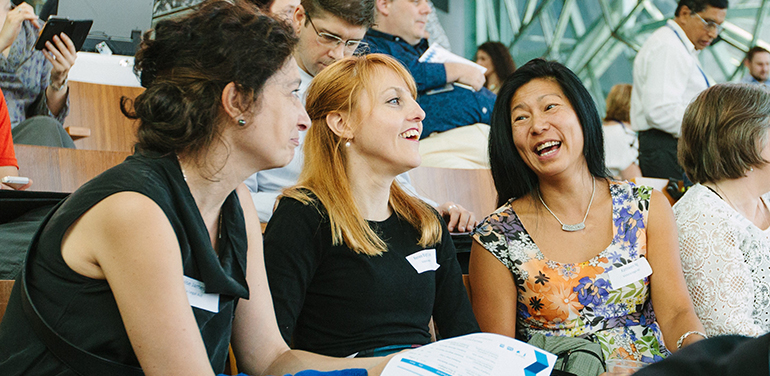 Three women attending a lecture