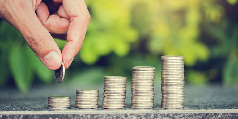 Person stacking coins in piles