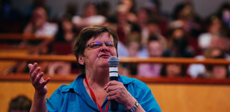 Woman on stage addressing conference