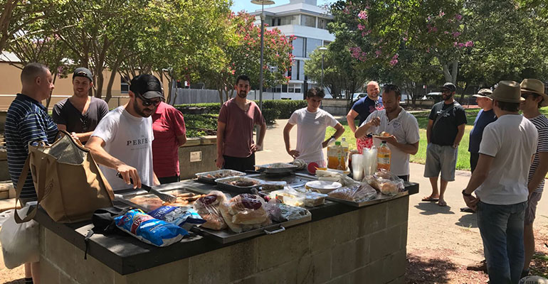 Group of men gathered at a Mr Perfect bbq