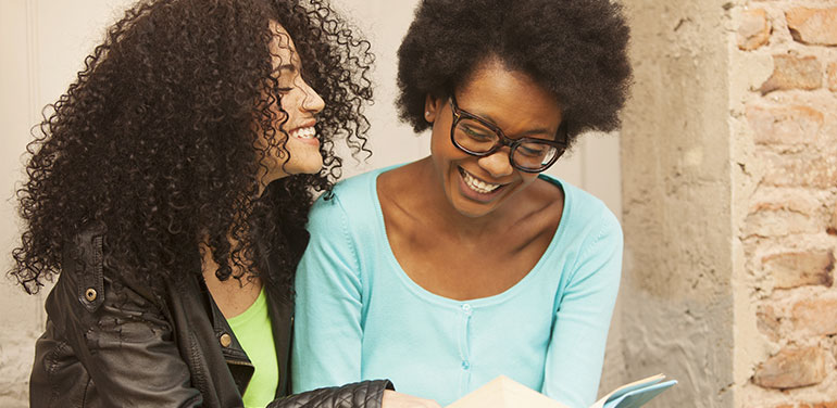 Two women reading book