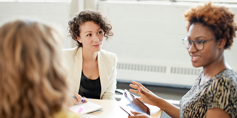 Three women working at a table