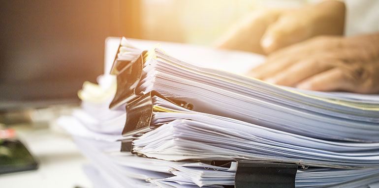 Person sorting through stack of paperwork