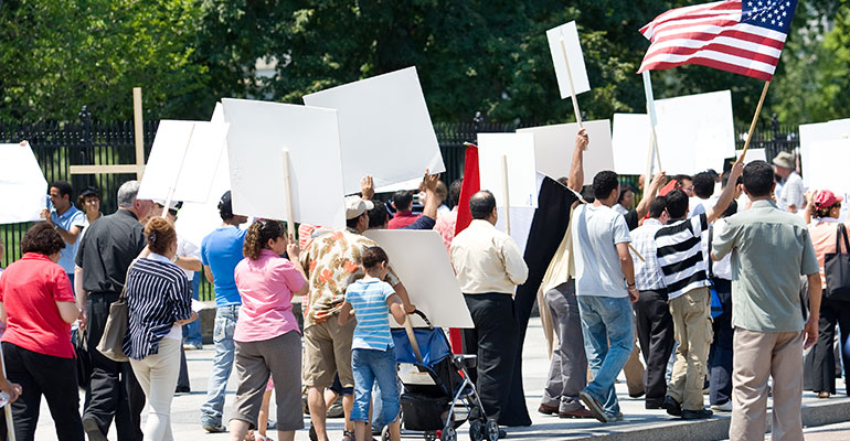 Protesters marching in the US with signs and flags