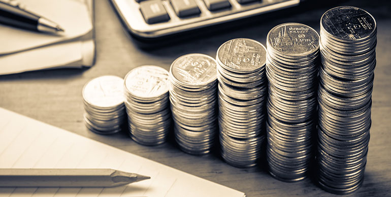 piles of money on a desk