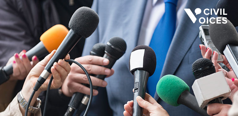 man speaking to the press