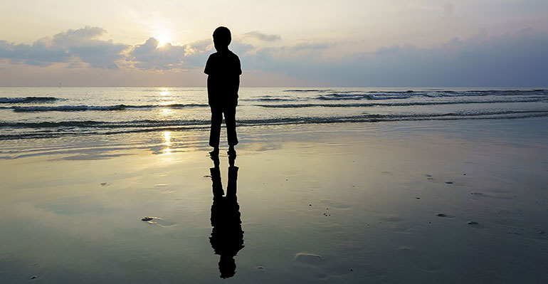 Silhouette of a boy on a beach