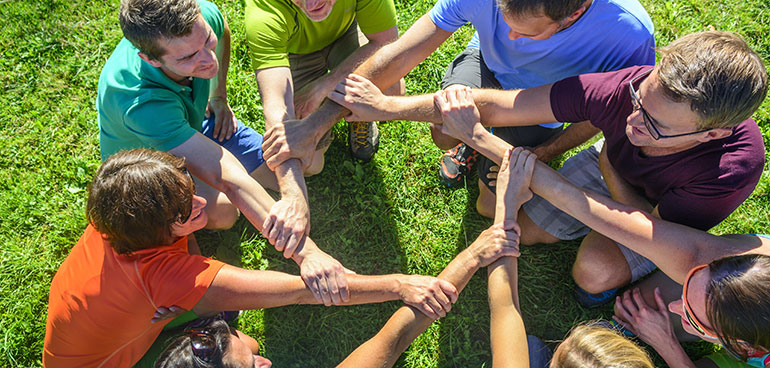 Group of people with locked arms