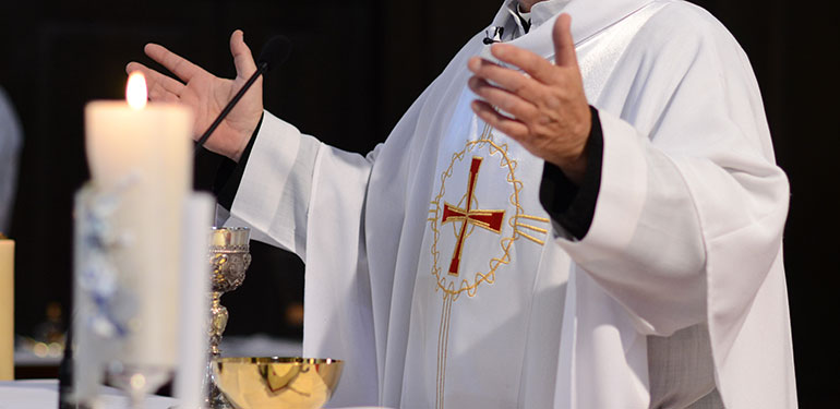 priest giving sermon