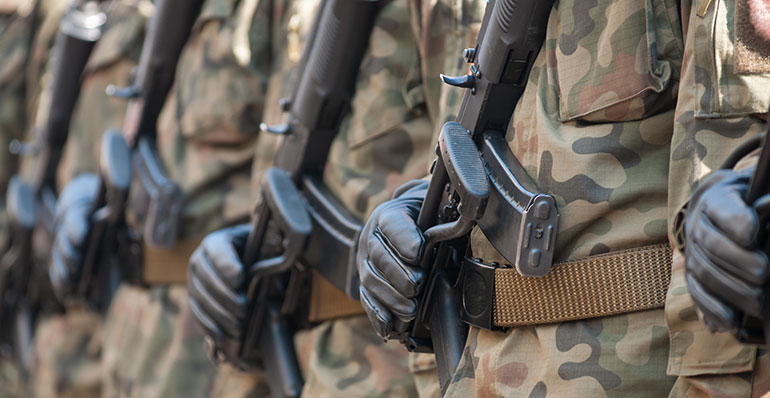 Soldiers with guns standing in formation