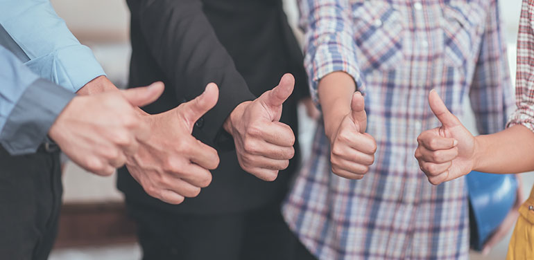 group of people with their thumbs up