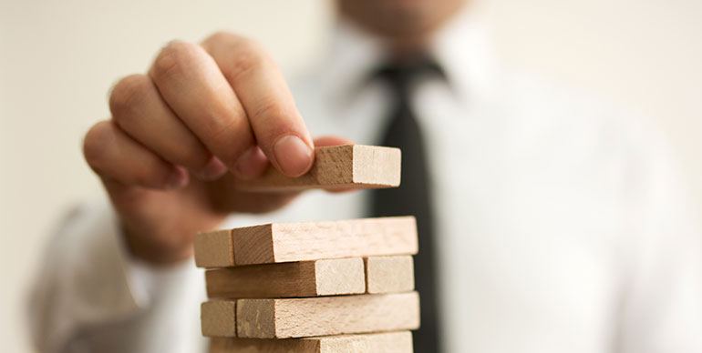 Man putting a block on a tower