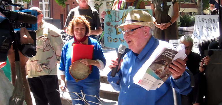 Father Maguire speaks at the AUWU protest over welfare reform