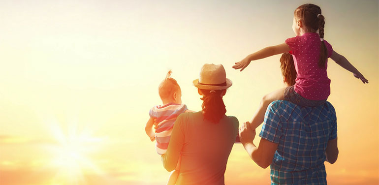 Family look out at sunset