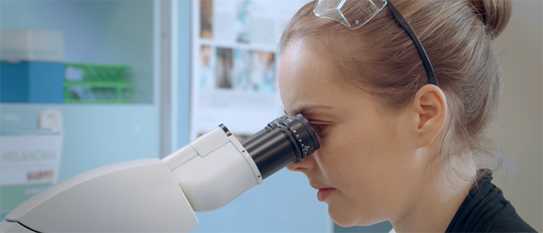 Scientist looking in microscope