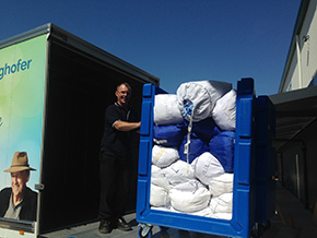 Employee doing the laundry at Vanguard Laundry Services