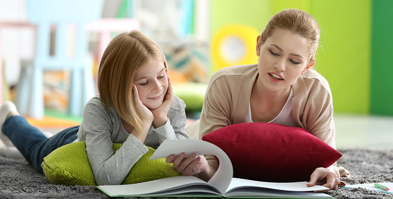 child and woman reading