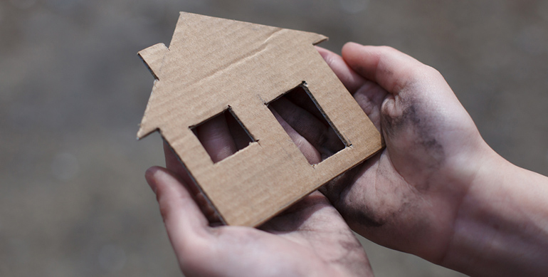 cardboard house in hands