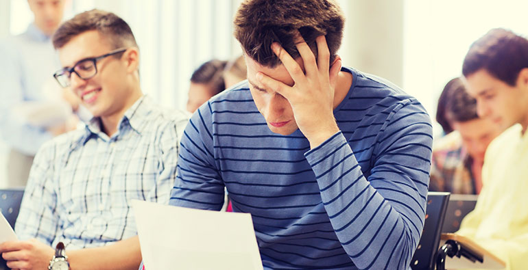 student looking stressed at paper