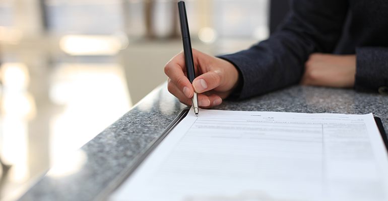 woman signing letter