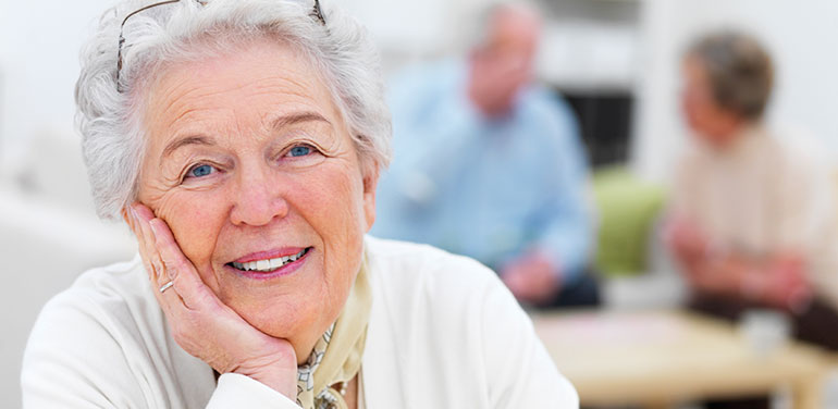 Elderly lady resting her face in her hand