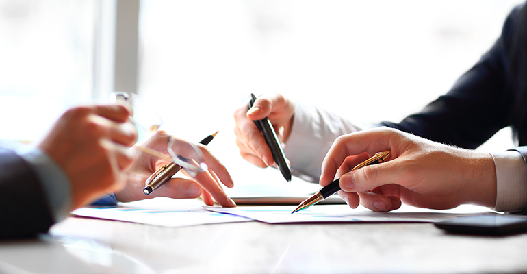 people signing documents