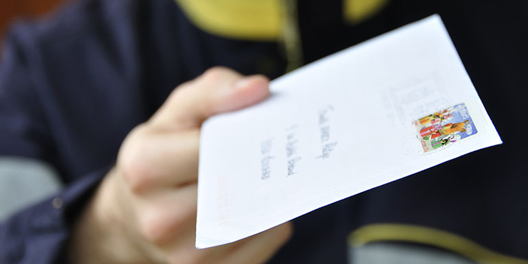 Postman handing over a letter