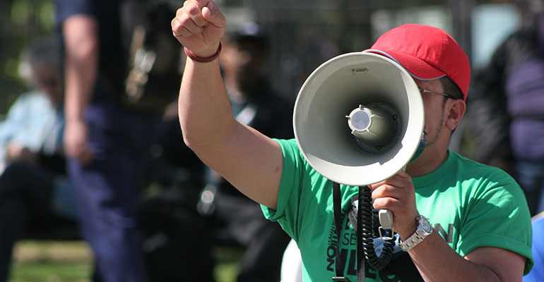 protester speaking into a megaphone