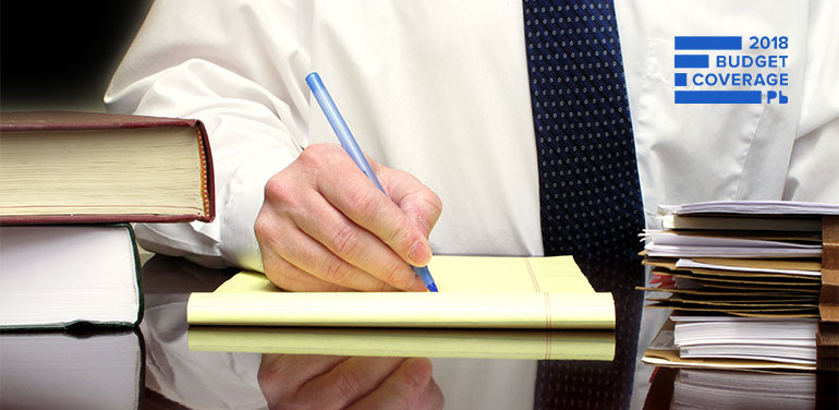 Business man doing paper work at his desk