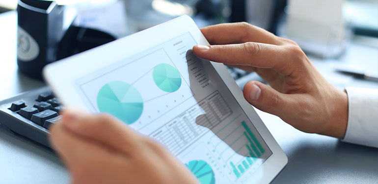 man looking at graphs on computer