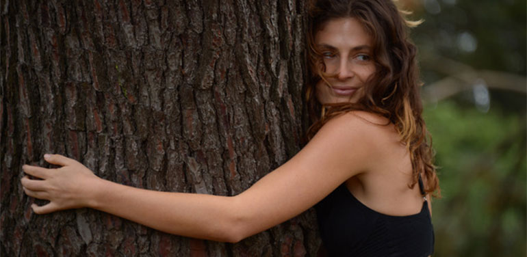 Model wearing The Very Good Bra hugging a tree