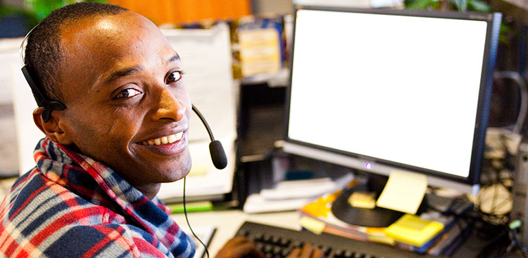 person smiling at his desk