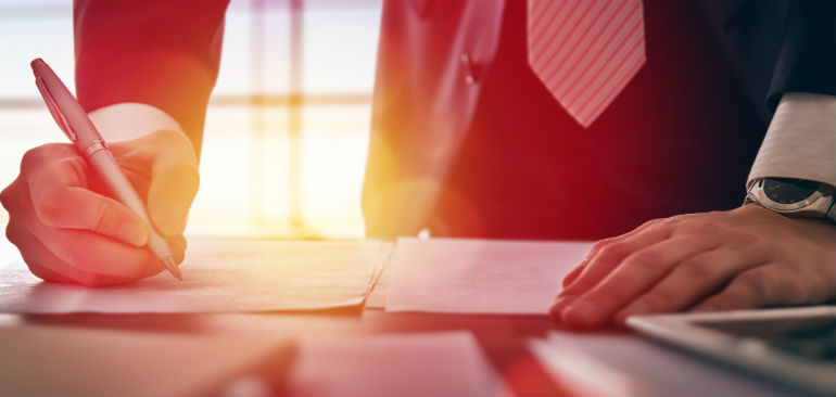 businessman signing documents