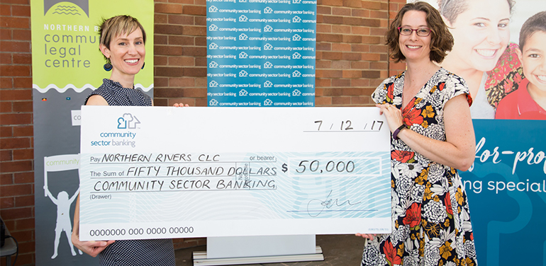 Two women holding big cheque