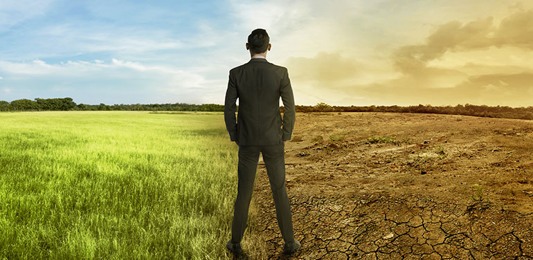 businessman looking at the effects of climate change