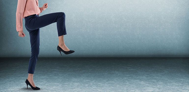 Business woman standing on one leg