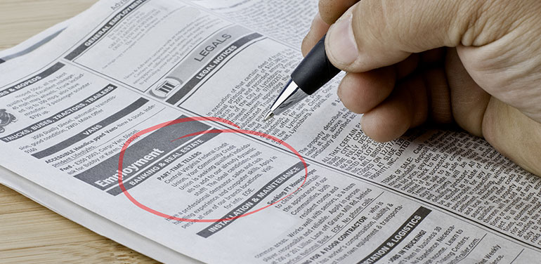 Close up of hand circling job in a newspaper