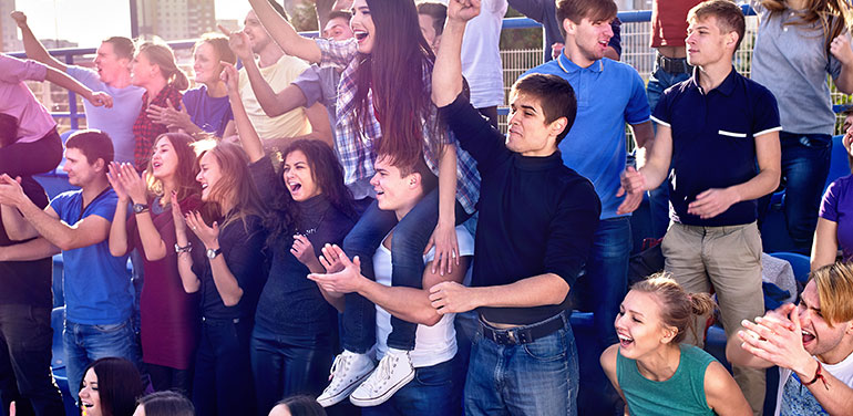 sports fans cheering at a match