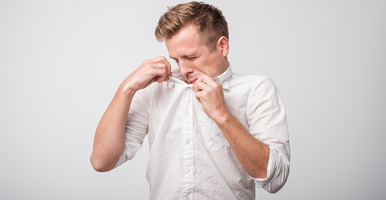 Guy smelling his armpit