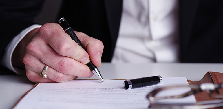 Man writing at a desk